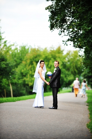 bride and groom walking along the streetの写真素材