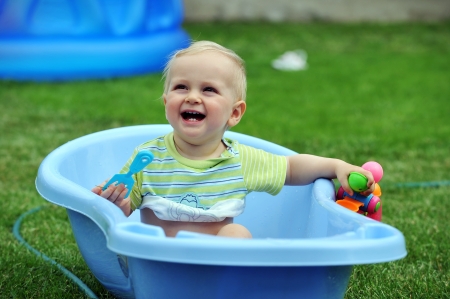  little boy with toys in blue bathの写真素材