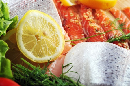 pieces of  salmon with spice on wooden plateの写真素材