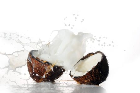 cracked coconut with big splash, isolatedの写真素材