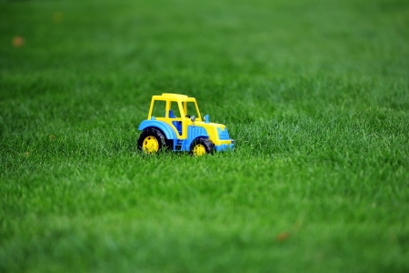 toy tractor on green grassの写真素材