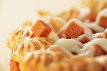 Delicious caramel's  cupcake with white icing closeupの写真素材