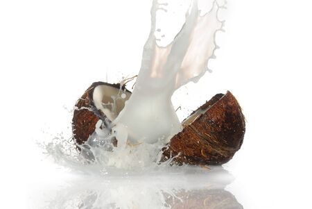 cracked coconut with big splash, isolatedの写真素材