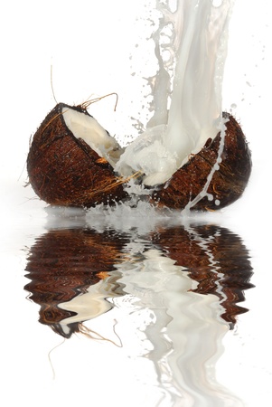 cracked coconut with big splash, isolatedの写真素材