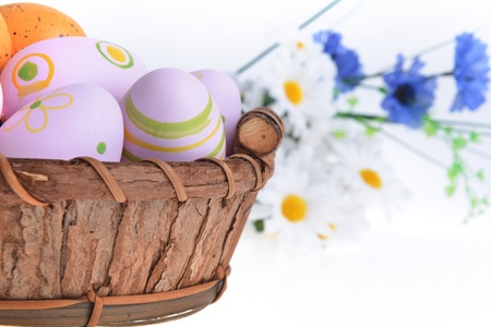 wooden basket of easter eggs with wildflowersの写真素材