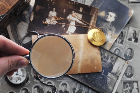 pocket clock with  chain on background of old photosの写真素材