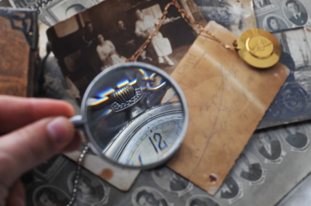 pocket clock with  chain on background of old photos