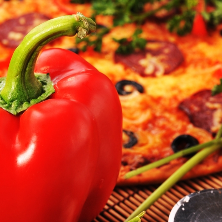 Close up of  pizza with tomatoes, cheese, black olives and  peppers.の写真素材
