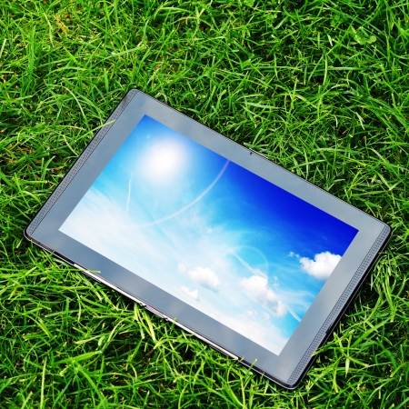 generic tablet computer (tablet pc)  on green grassの写真素材