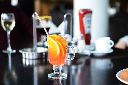 Cocktail with orange juice and ice cubes の写真素材