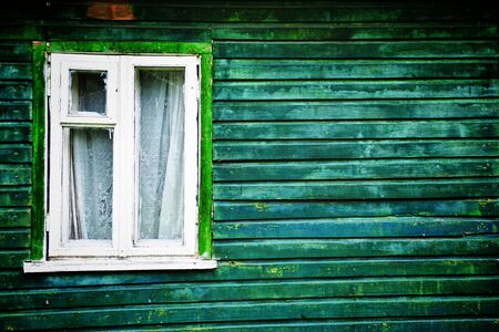 Old-fashioned  white window of green houseの写真素材