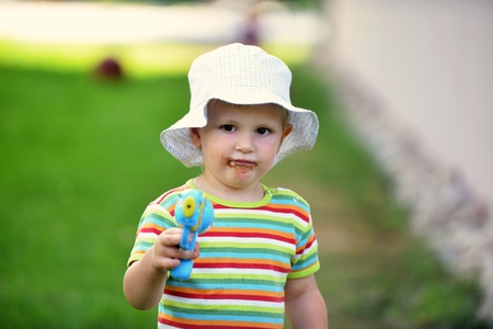 happy little boy in cap outdoors
