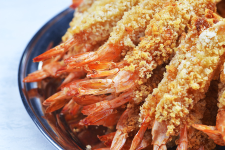  plate of sauteed prawns in breadcrumbs with sauce
