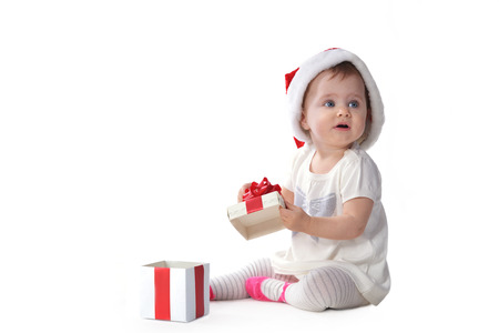 adorable baby girl in Santa hat  with  gift boxのeditorial素材