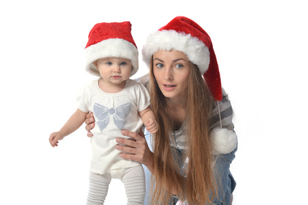 Cheerful baby girl and woman in Santa Claus hat. のeditorial素材