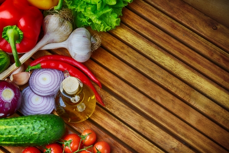 fresh vegetables and olive oil on wooden backgroundの写真素材