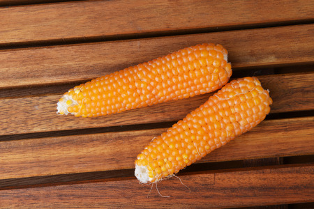 Fresh ear of corn on wooden background