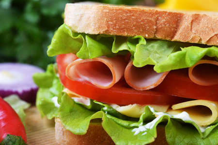 Fresh and tasty sandwich on wooden cutting boardの写真素材