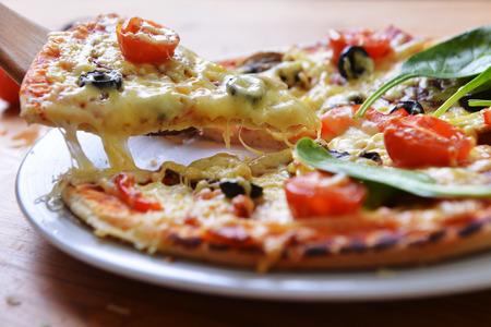 fresh baked pizza with olives and peppers