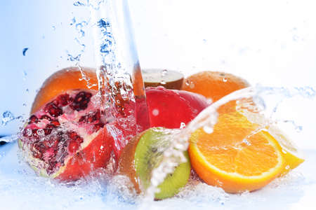slices of kiwi,  orange, pomegranate and  lemon  in  waterの写真素材