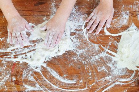 on kitchen table preparing dough