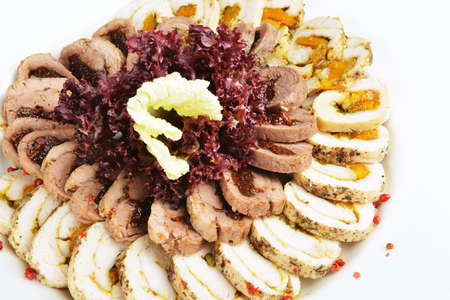 Thinly sliced pieces of meat on  white plateの写真素材