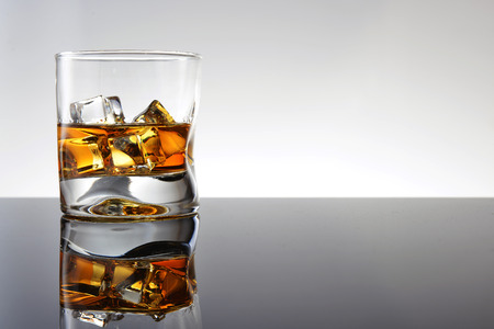 Whiskey with ice in simple glassの写真素材