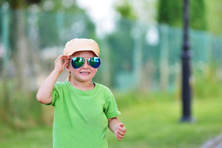 little boy  with sunglasses in summer parkの写真素材