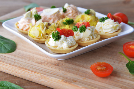 tartlet with cream and dill on dishの写真素材
