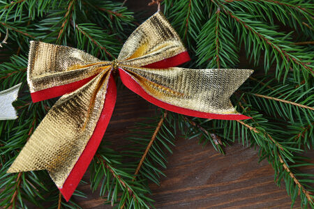 branch of green fir tree with christmas toys on wooden backgroundの写真素材