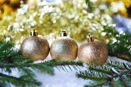 branch of green fir tree with christmas toys on white backgroundの写真素材