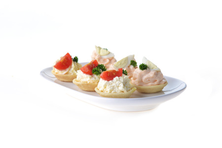 tartlet with cream and dill on dishの写真素材