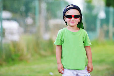 little boy  with sunglasses in summer parkの写真素材