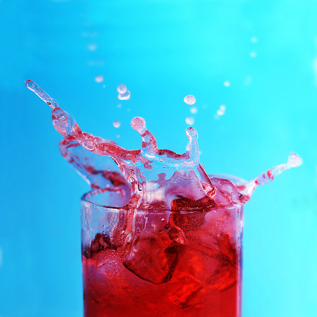 glass with  drink and  ice are on  surfaceの写真素材
