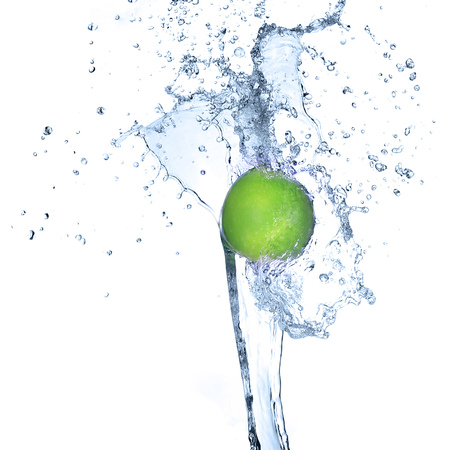 Green apple in splash of water isolatedの写真素材