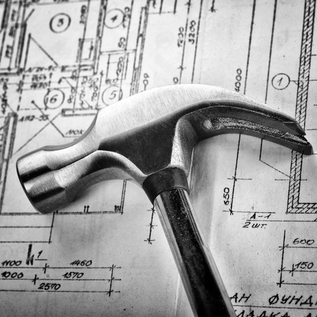 Metal hammer on drawings close upの写真素材