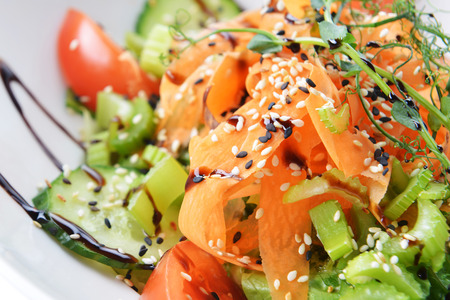 salad of vegetables and meat on dishの写真素材