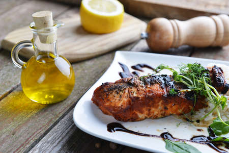 roasted fish,  rice  and vegetables on dishの写真素材