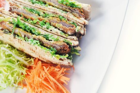 sandwiches with meat and vegetables on  plateの写真素材