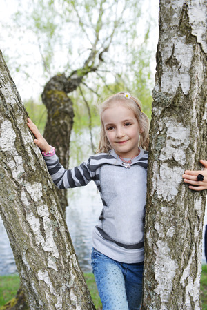 pretty girl near tree in parkの写真素材