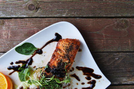 Roasted fish,  rice  and vegetables on dish