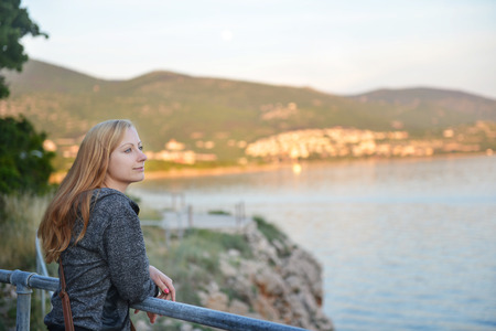 Beautiful young woman  looking at seaの写真素材