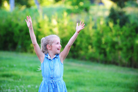 girl play with bubble blower on green lawn.