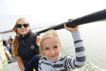 mother with children sailing  on passenger ferry in seaの写真素材