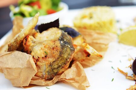 roasted fish, rice and vegetables on dish
