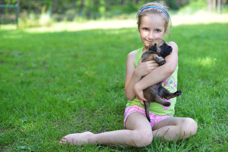 girl playing with dogs on grassの写真素材