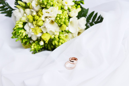 wedding bouquet and rings on white backgroundの写真素材