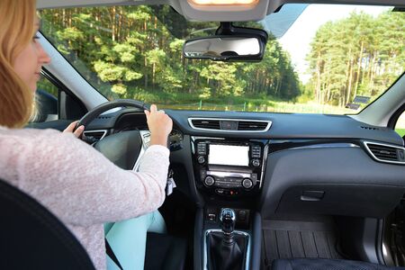 woman sit in modern  car in front of dashboard