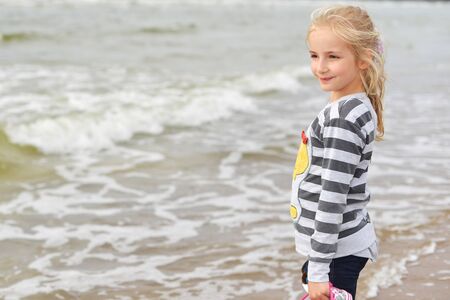 Little girl  playing on  sea beachの写真素材