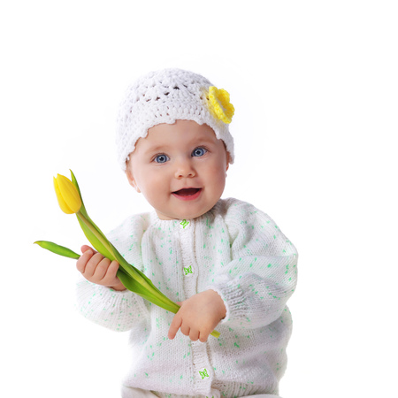 Cute baby girl holding yellow tulipの写真素材